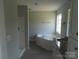 Modern bathroom featuring a soaking tub, vanity with granite countertop, and tiled shower at 122 Mason Tanner Ct # 5, Rock Hill, SC 29730