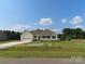 Charming single-story home featuring a welcoming front porch, attached garage, and a well-manicured lawn at 122 Mason Tanner Ct # 5, Rock Hill, SC 29730