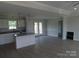Open-concept kitchen features an island with granite countertops, modern appliances, and abundant natural light at 122 Mason Tanner Ct # 5, Rock Hill, SC 29730