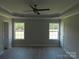Spacious main bedroom featuring a tray ceiling, ceiling fan, and windows at 122 Mason Tanner Ct # 5, Rock Hill, SC 29730