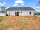 Exterior of the home with a door to the backyard and a freshly seeded lawn at 1313 Gidney St, Shelby, NC 28150