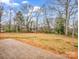 View of the home's backyard with newly seeded grass and bare trees at 1313 Gidney St, Shelby, NC 28150