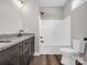 Well-lit bathroom featuring a sleek, enclosed shower and tub adjacent to a granite-topped vanity and white toilet at 1313 Gidney St, Shelby, NC 28150