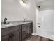 Modern bathroom featuring a double vanity with granite countertops and a sleek, enclosed shower and tub at 1313 Gidney St, Shelby, NC 28150