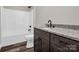 Sleek bathroom featuring a modern vanity with a granite countertop and tub and shower combination at 1313 Gidney St, Shelby, NC 28150