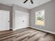 Bright bedroom showcasing wood-look floors, a window with an outdoor view, and closet doors at 1313 Gidney St, Shelby, NC 28150