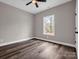 Bright bedroom with natural light, wood-look floors, ceiling fan, and neutral walls providing a calming atmosphere at 1313 Gidney St, Shelby, NC 28150