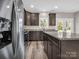 Bright kitchen boasts stainless steel appliances, dark cabinetry, granite countertops, and French doors to the backyard at 1313 Gidney St, Shelby, NC 28150