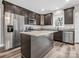 Gourmet kitchen features stainless appliances, dark wood cabinets, granite counters, and new luxury vinyl plank flooring at 1313 Gidney St, Shelby, NC 28150