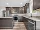 Modern kitchen with stainless steel appliances, dark wood cabinetry, granite countertops, and stylish flooring at 1313 Gidney St, Shelby, NC 28150