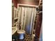 Bathroom with a white toilet, shower and a gray curtain at 316 Reese St, Gastonia, NC 28056