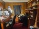 Cozy bedroom featuring wood paneling, a desk and chair, and plenty of storage shelves at 316 Reese St, Gastonia, NC 28056