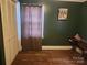 Bedroom featuring dark green walls, closet and hardwood floor at 316 Reese St, Gastonia, NC 28056