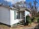 A charming home with white siding, green shutters, a cozy porch, and an American flag for a touch of patriotism at 316 Reese St, Gastonia, NC 28056