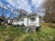 Charming one-story home with white siding and a cozy front porch with colorful chairs, perfect for relaxing at 316 Reese St, Gastonia, NC 28056