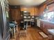 Well-lit kitchen with wood floors, stainless steel appliances, and vintage wood cabinets, seamlessly combining style and functionality at 316 Reese St, Gastonia, NC 28056