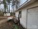 Exterior view of a white shed with a small window, a door, and peeling paint at 316 Reese St, Gastonia, NC 28056