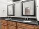 The luxurious bathroom showcases a double vanity with granite countertops and stylish framed mirrors at 3334 Cloninger Rd, Dallas, NC 28034