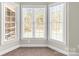 This bright bedroom nook boasts bay windows with blinds, offering a peaceful and inviting space at 3334 Cloninger Rd, Dallas, NC 28034