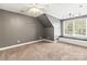 Spacious bedroom with a window seat, neutral carpet, and modern lighting at 3334 Cloninger Rd, Dallas, NC 28034