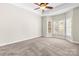 Spacious bedroom with neutral carpet, a ceiling fan, and a wall of windows for plenty of natural light at 3334 Cloninger Rd, Dallas, NC 28034