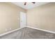 Neutral bedroom featuring plush carpeting, fresh paint, and a classic white paneled door at 3334 Cloninger Rd, Dallas, NC 28034