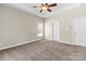 This neutral bedroom features carpeted floors, a ceiling fan, and a window to maximize natural light at 3334 Cloninger Rd, Dallas, NC 28034