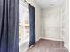 This open closet boasts a bright window for natural light, and shelving for optimal organization at 3334 Cloninger Rd, Dallas, NC 28034