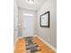 Entryway featuring hardwood floors, white door, and mirror at 3334 Cloninger Rd, Dallas, NC 28034