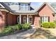 Close-up of home's front entry with brick facade, pillars, and attractive landscaping at 3334 Cloninger Rd, Dallas, NC 28034