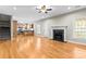 Open-concept living room with wood floors, fireplace, and seamless flow to kitchen at 3334 Cloninger Rd, Dallas, NC 28034