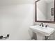 Pedestal sink and framed mirror featured in the powder room at 3334 Cloninger Rd, Dallas, NC 28034