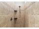 The tiled shower features mosaic accents, sleek fixtures, and convenient shelving for a spa-like experience at 3334 Cloninger Rd, Dallas, NC 28034