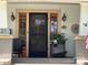 Charming home featuring a black screen front door framed by sidelights, complemented by decorative accents and an inviting entrance at 421 Mitchell Ave, Salisbury, NC 28144