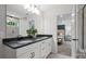 Elegant bathroom featuring double sinks, white cabinets, modern fixtures, and a view into the bedroom at 5231 Hatcher Creek Rd # 44, Charlotte, NC 28215