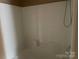 Bathroom features a shower with white tub surround and shower head at 5650 Kimmerly Woods Dr, Charlotte, NC 28215