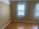 Bedroom with hardwood floors, natural light from windows and neutral wall color at 5650 Kimmerly Woods Dr, Charlotte, NC 28215