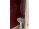 A half bathroom featuring a pedestal sink, mirror, and decorative wall paint at 5650 Kimmerly Woods Dr, Charlotte, NC 28215