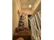 Hallway with staircase, providing access to the upper levels of the home, enhanced by decorative elements at 5650 Kimmerly Woods Dr, Charlotte, NC 28215