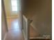 Upstairs hallway with neutral walls, wood floors, and white banister at 5650 Kimmerly Woods Dr, Charlotte, NC 28215
