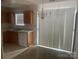 A well lit kitchen area with laminate countertops, a sink, and dining area at 5650 Kimmerly Woods Dr, Charlotte, NC 28215