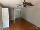 A spacious living room featuring hardwood floors and a ceiling fan at 5650 Kimmerly Woods Dr, Charlotte, NC 28215