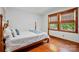 Bedroom features hardwood floors, two large windows, and a beautifully crafted wooden bed frame at 7204 E 218 Hwy, Marshville, NC 28103