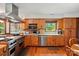 Well-equipped kitchen with wooden cabinets, stainless steel appliances, and hardwood floors at 7204 E 218 Hwy, Marshville, NC 28103