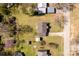 A bird's eye view of a residential property with a fenced yard, sheds, and mature trees at 727 Fickling Dr, Lancaster, SC 29720