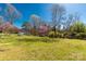 Spacious backyard showcasing lush greenery and surrounding trees at 727 Fickling Dr, Lancaster, SC 29720