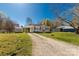 Exterior view of a cozy home with a gravel driveway and well-maintained yard at 727 Fickling Dr, Lancaster, SC 29720