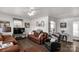 Cozy living room with modern brown leather sofas and a ceiling fan for added comfort at 727 Fickling Dr, Lancaster, SC 29720