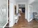 Inviting foyer with hardwood floors, white console table, and open doorway to living area at 7882 Old Brook Rd, Sherrills Ford, NC 28673