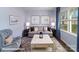 Cozy living room with comfortable seating, a coffee table, and natural light from the window at 7882 Old Brook Rd, Sherrills Ford, NC 28673